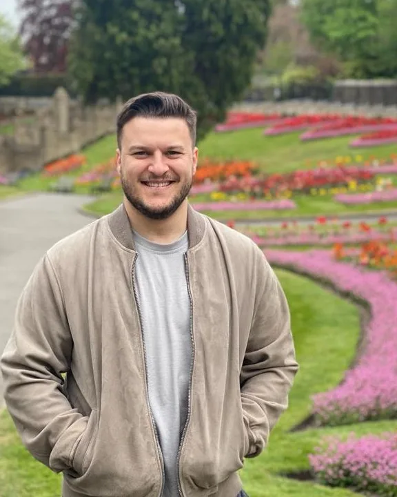 Isaac Danna standing in a tulip garden